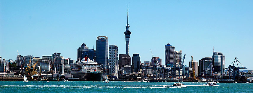 Skyline of Auckland, New Zealand, harbor with the Queen Mary 2 seen from Devonport