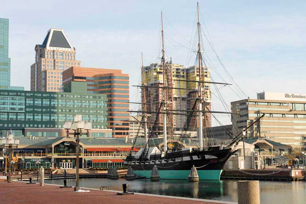 Baltimore Harborplace with USS Constellation in Downtown Baltimore, Maryland, USA