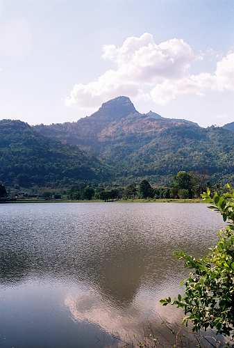 Vat-Phou, Phu Kao Mountain with its natural Linga (on second peak) behind Vat Phou Temple and one of the barays (tanks) in foreground.