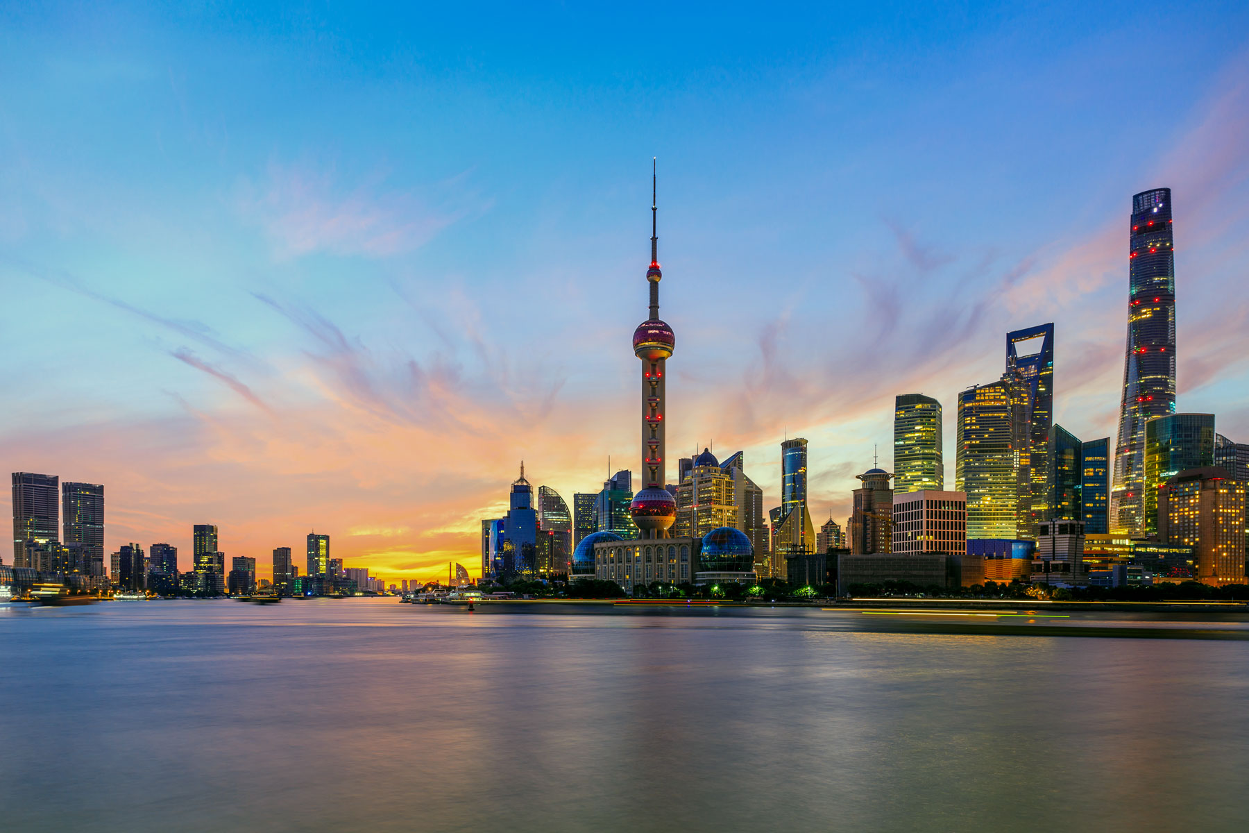 Shanghai skyline with Oriental Pearl Tower at dusk.