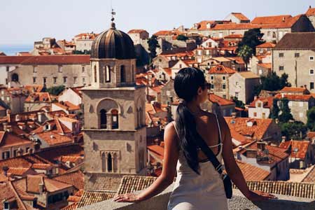 A youn lady enjoys the view of Old City of Dubrovnik