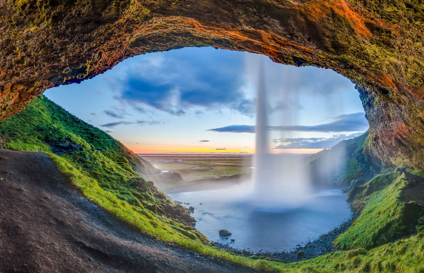 View from the back of the Seljalandsfoss waterfall in Suðurland