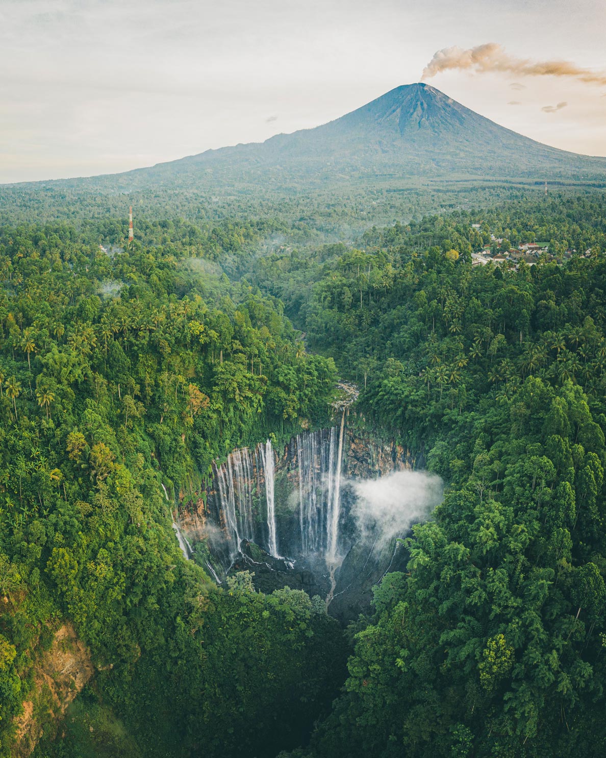 Tumpak Sewu waterfall with Mount Semeru in the background.