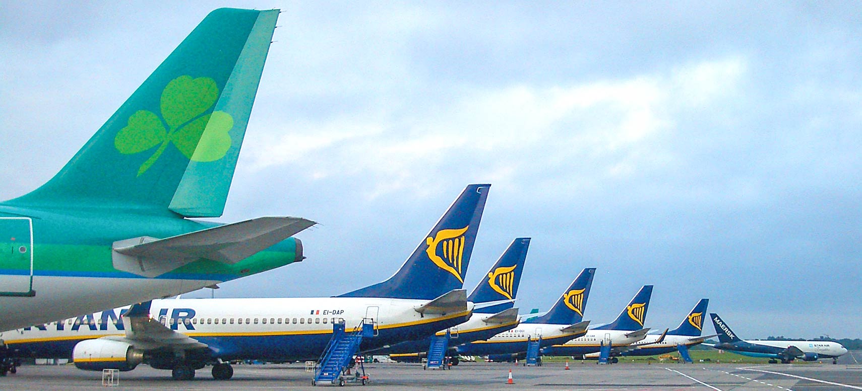Aer Lingus plane and several Ryanair aircraft at Dublin Airport