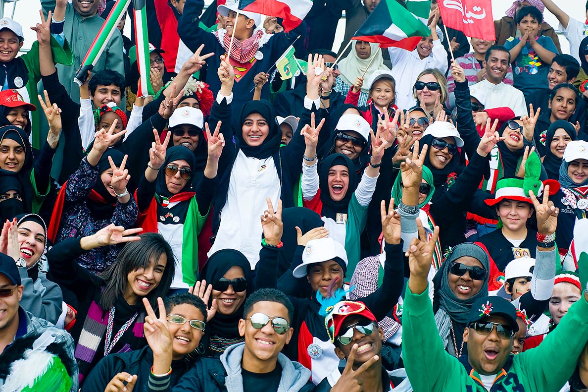 Kuwaiti youth celebrating during the 50/20 Celebration parade in Kuwait