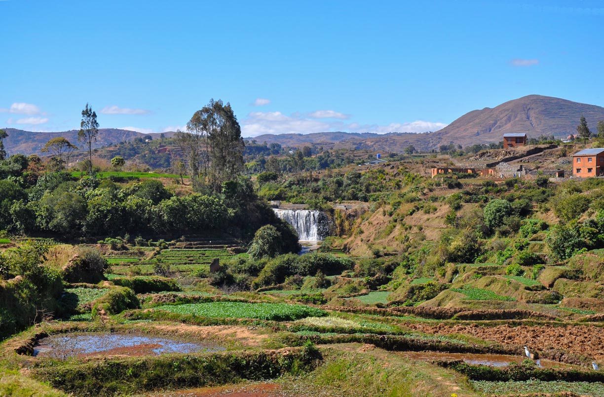 A waterfall and rice paddies in the highlands of Madagascar.
