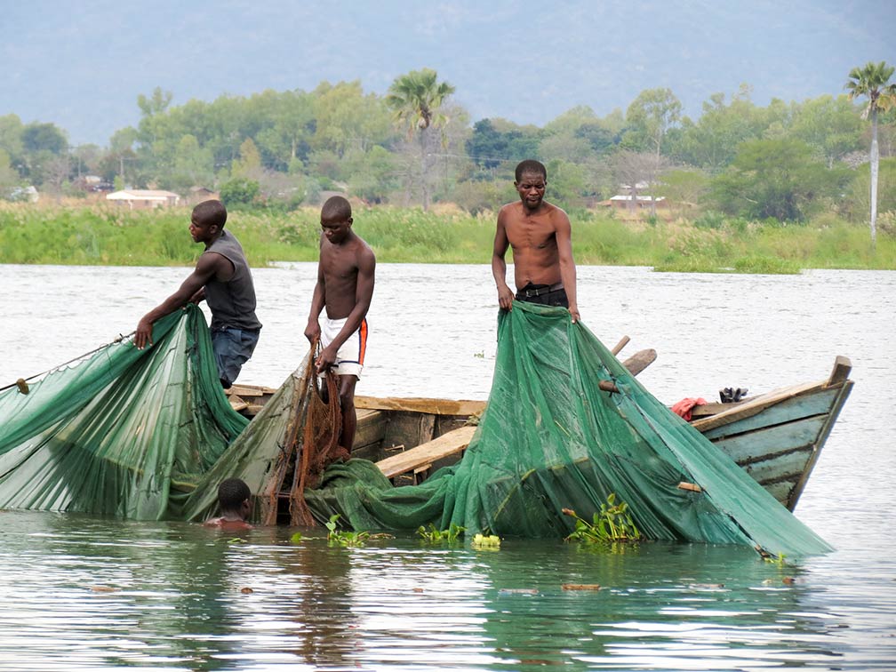 Three men fishing on the Shire River