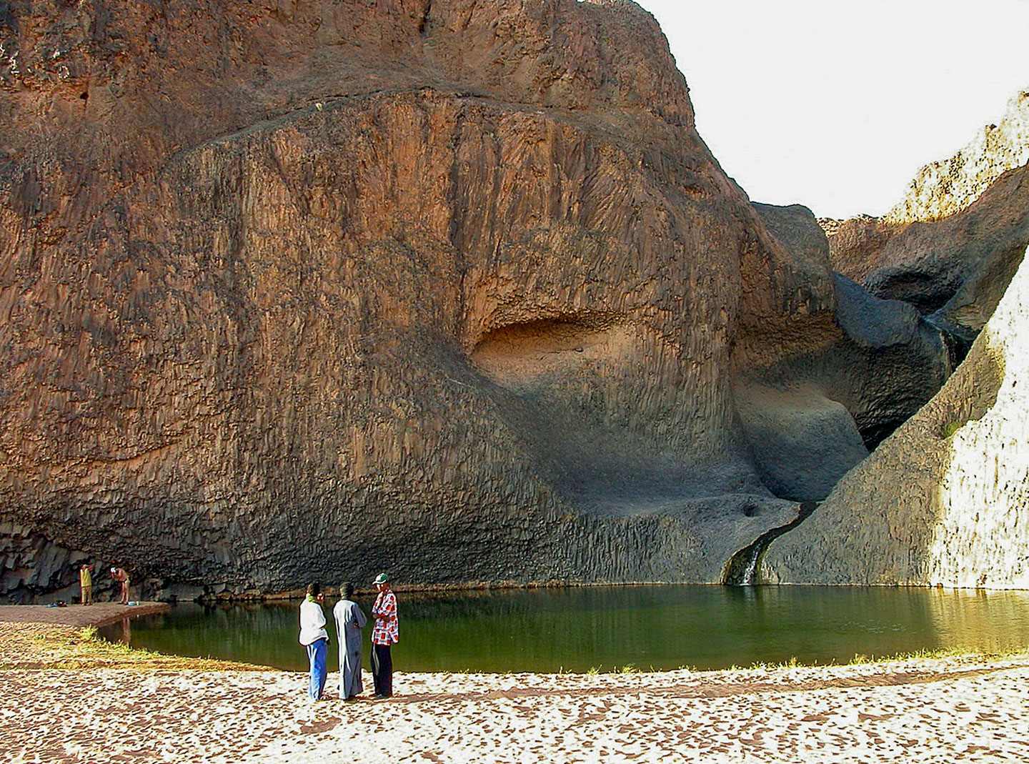 People at the Guelta of Timia, Niger, a guelta is a water reservoir that forms within rock formations in the Sahara and the Arabian Desert.