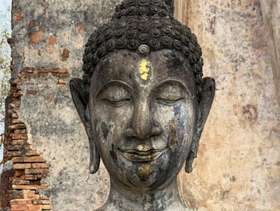 Head of a smiling Buddha from the Sukhothai era.