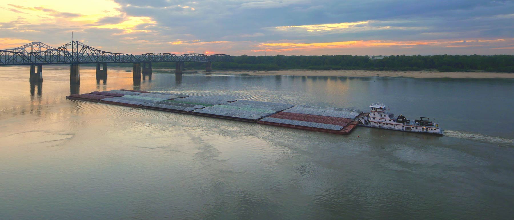 A towboat pushing loaded barges on the Lower Mississippi River