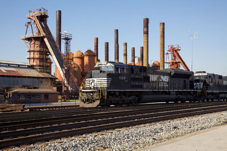 A Norfolk Southern train passes the Sloss Furnaces