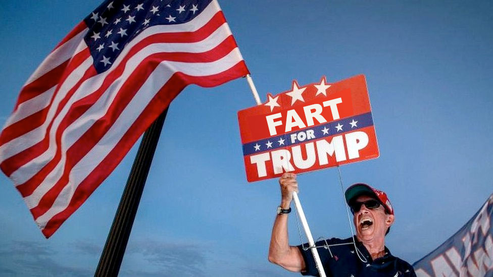 A fake Trump supporter waves an American flag and holds a placard that reads: Fart for Trump