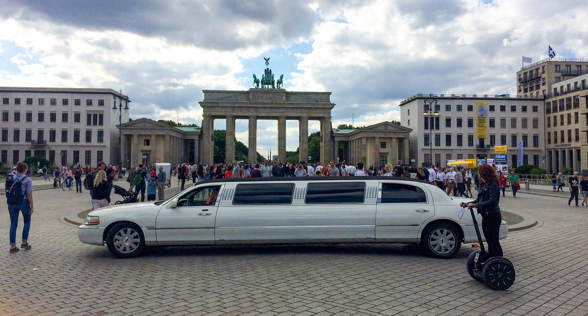 Tourists at Pariser Platz with Brandenburg Gate in Berlin