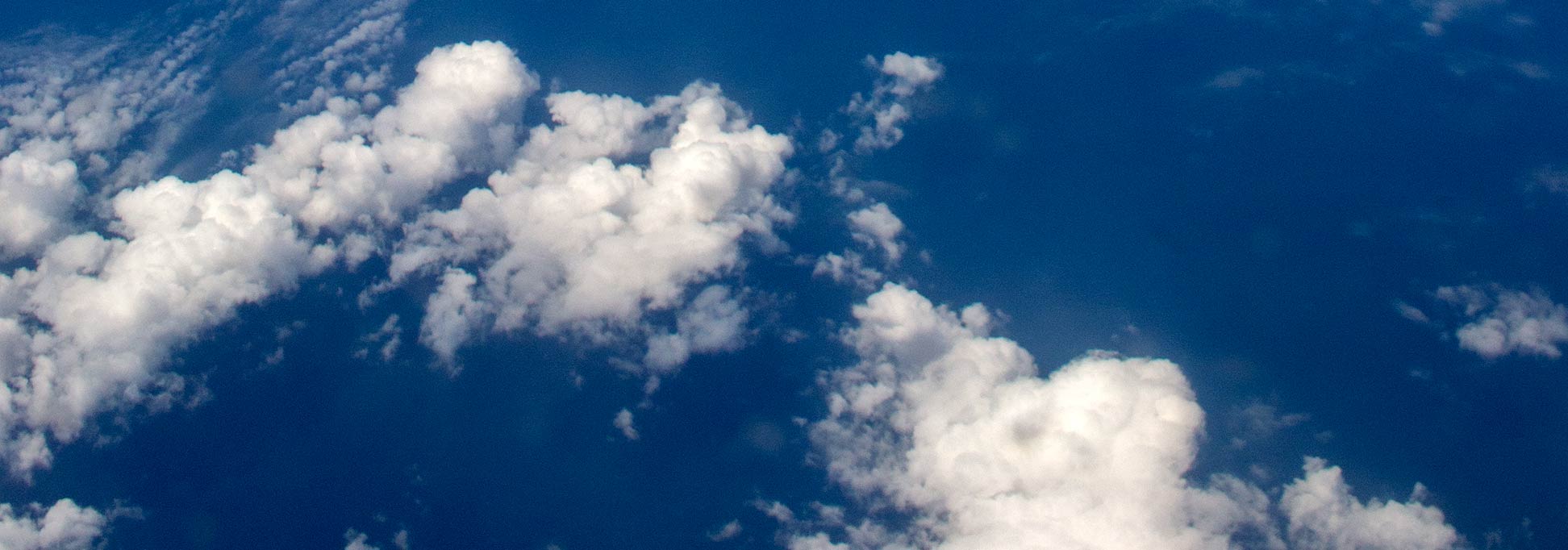 Over the clouds - some scattered clouds below